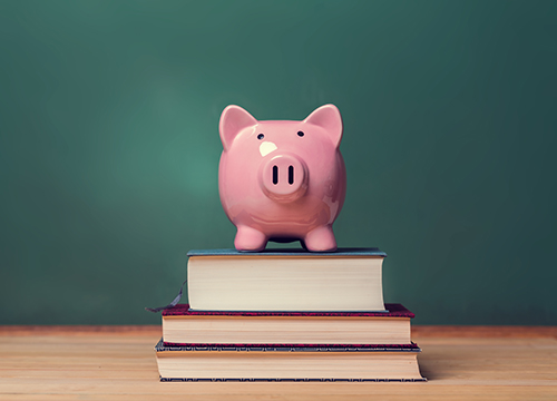 Piggy bank on top of school books